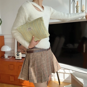 Chic striped canvas storage bag displayed in a cozy lifestyle indoor setting