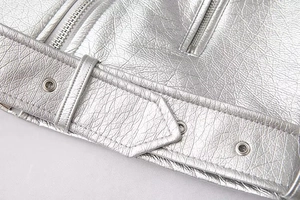 Close-up of metallic silver biker jacket with grained texture and belted zipper detail