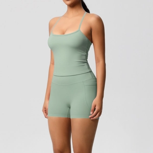 Detail of mint green yoga set showing side pocket on high-waisted shorts and slim fit vest
