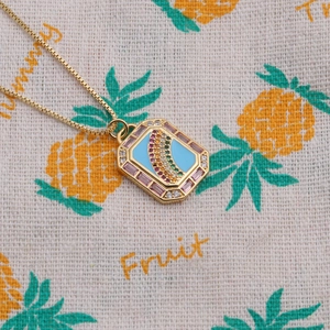 Detail of gold-plated rainbow necklace with blue enamel and pink zircon stones