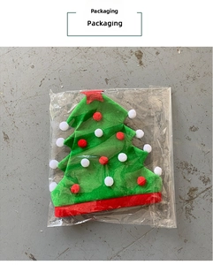 Detailed packaging view of a green felt Christmas tree hat with red and white pompoms