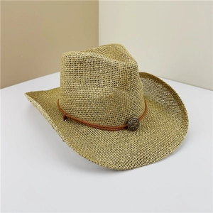 Detail of hollow woven straw cowboy hat featuring brown rope band and vintage metal buckle