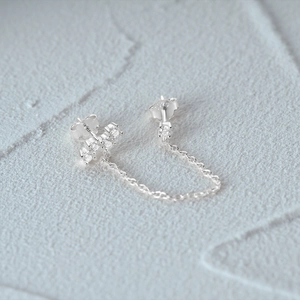 Macro shot of S925 sterling silver chain earrings with white zircon accents and S925 stamp