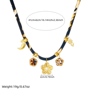 Leopard print fabric necklace with gold moon and flower pendant showing size and weight