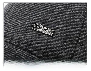 Detailed macro view of dark grey twill fabric and S SPORT CLASSIC metal badge on hat