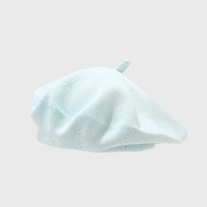 Detailed knit texture of light blue cotton beret hat with a soft mesh surface
