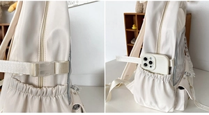 Detail view of the cream nylon backpack side pocket with elastic mesh and adjustable buckle