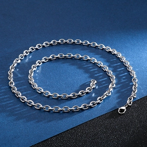 Macro shot of polished silver stainless steel link chain on dark textured background