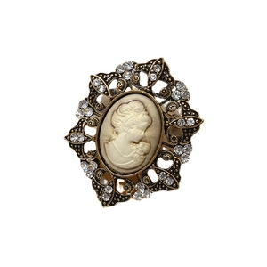 Vintage relief portrait brooch in gold-finish metal frame with sparkling rhinestones