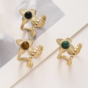 Detail of vintage flower rings with black green and brown stones on beaded double bands