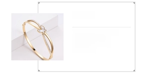 Detail of 316 stainless steel gold butterfly bangle with shell inlay and small diamonds