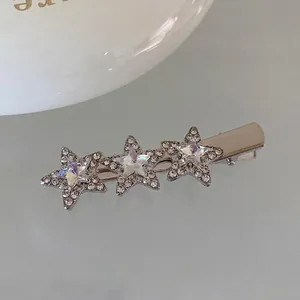 Macro shot of silver metal star hair clips with sparkling pink rhinestones and duckbill clasp