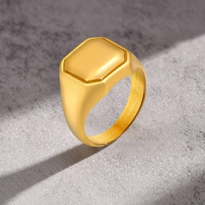 Macro detail of golden square signet ring showing polished finish and brushed inner band