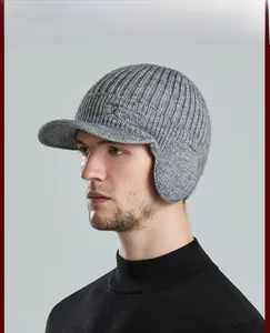 Side view of men's grey knit beanie with visor and earflaps, featuring Sport embroidery
