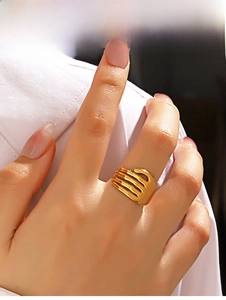 Detailed view of a gold-plated stainless steel hugging hands open ring on a finger