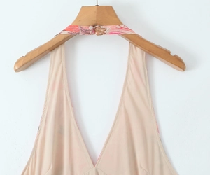Detail of floral halter neck strap and deep V-neckline on a summer maxi dress