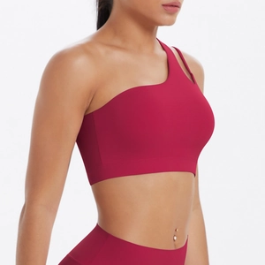 Close-up of deep red one-shoulder sports bra with seamless high-elastic fabric design