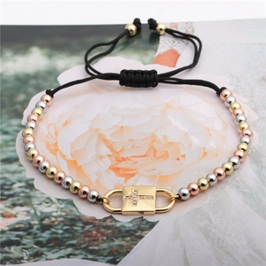 Three-tone metal beaded adjustable cross bracelet with zircon pavé pendant on black cord
