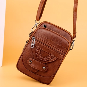 Classic brown PU leather crossbody bag with multiple zippers and metallic rivet details