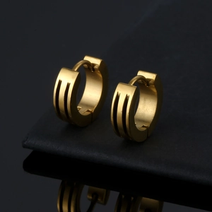 Polished gold titanium steel hoop earrings with parallel grooves on black background