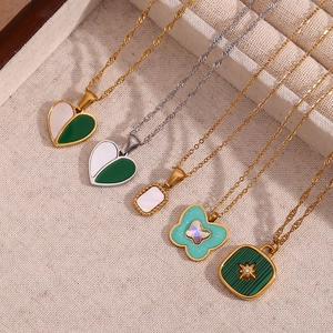 Close-up of heart and star pendants on 18K gold and silver plated chains in a jewelry box