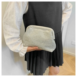 Detail of a luxury shell-shaped evening clutch bag with sparkling silver rhinestones