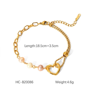 Detail of gold stainless steel bracelet featuring three pearls and a heart charm