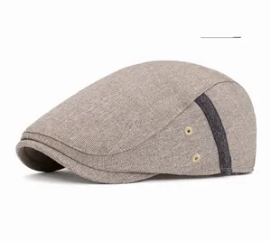 Detail view of beige breathable beret hat with side vent holes and textured fabric