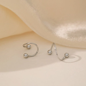 Detailed macro view of S925 sterling silver spiral earring with polished metal spheres