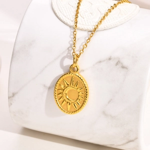Detail of 18K gold-plated sun and moon pendant on a polished stainless steel chain necklace