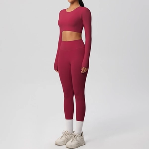 Side view of dark red long sleeve crop top and high waist yoga leggings set