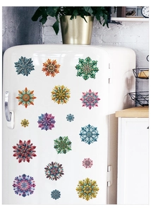Vibrant snowflake window decals in various colors displayed on a white vintage refrigerator