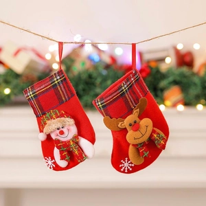 Christmas stocking gift bags with snowman and reindeer dolls hanging on a festive tree