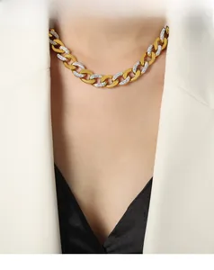 Macro shot of two-tone gold and silver chunky chain necklace with pavé zircon settings