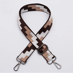 Detail of adjustable gunmetal buckle on a retro geometric patterned wide shoulder strap