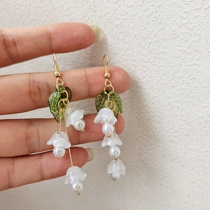 Elegant lily of the valley earrings with pink bell flowers, green leaves and pearls