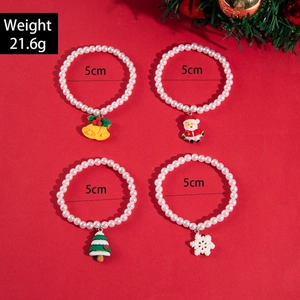 Detailed view of Christmas pearl bracelets featuring Santa, tree, and bell charms