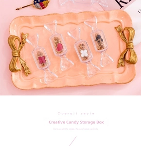 Macro shot of candy-shaped storage cases with clover and heart pendants inside