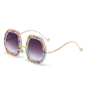 Cat eye sunglasses with purple gradient lenses and colorful sugar candy grain frames