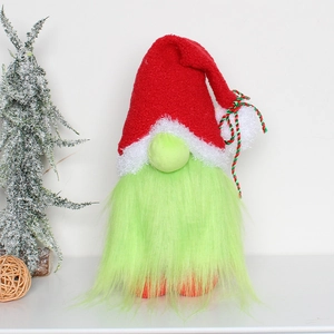 Detailed view of Christmas gnome plush with red pointed hat and green beard on white background