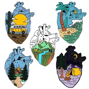 Five anatomical heart enamel pins featuring various nature landscapes and outdoor scenes