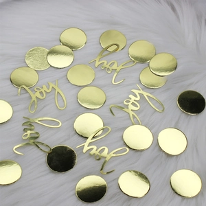 Golden Joy lettering and round sequins on white fur background for Christmas party decor
