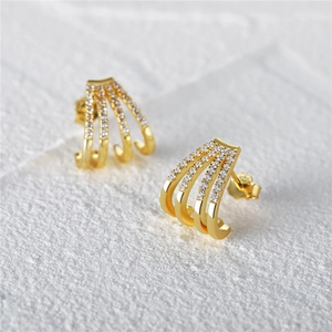 Close-up of gold-plated 925 silver multi-row claw earrings with sparkling zircon inlay