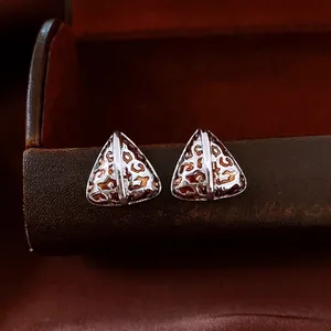 Vintage 14K gold plated triangular leopard print stud earrings for women on a box