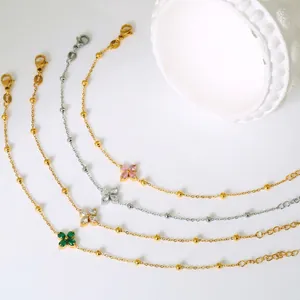 Titanium steel clover zircon bracelets set in gold and silver finish on white background