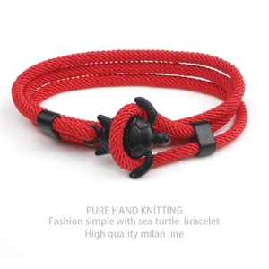 Detail of red handmade braided milan line bracelet with black sea turtle fastener