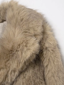 Close-up of thick light brown faux fur texture on a cropped fashion coat