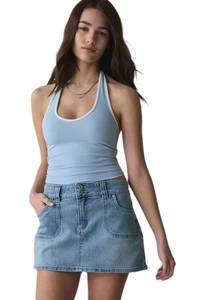 Detail of high-waist denim skirt with double buttons and light blue knit halter top