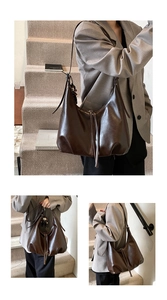 Detail view of deep brown leather tote bag featuring tassel accents and stylish doll charm