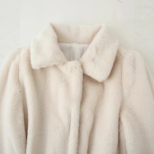 Elegant cream faux fur coat with belted waist and plush texture for a stylish winter look